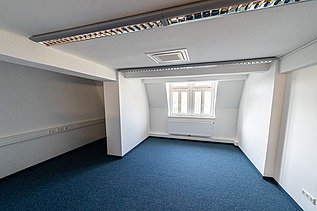 Modernisierter Büroraum im Verwaltungsgebäude Hansastraße 11 in Dresden mit Teppichboden, Dachschräge, integrierter Beleuchtung und hochwertigem Innenausbau – schlüsselfertige Sanierung durch SF‑Ausbau.