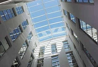 Lichtdurchflutetes Glasdach-Atrium der TU Bergakademie Freiberg mit moderner Architektur und großzügigen Fensterflächen – hochwertiger Innenausbau und Trockenbau von SF‑Ausbau.